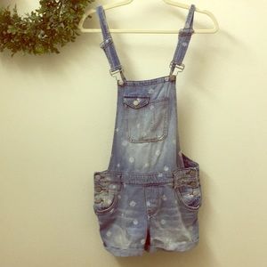 Cute overall shorts with a rustic daisy pattern.